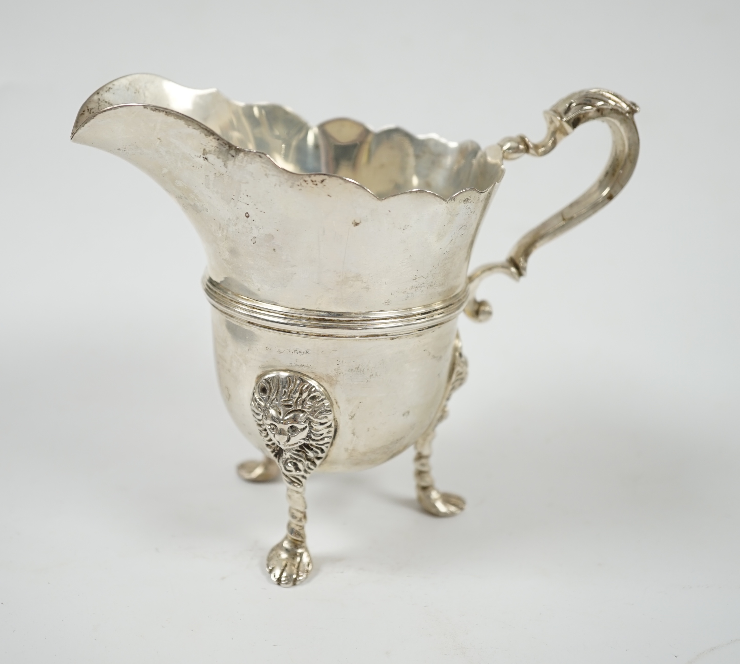 A George V silver cream jug, London 1911, height 11.5cm, 8.1oz. Condition - fair to good